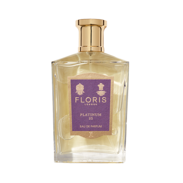 A clear glass bottle of Floris London EU Platinum 22 Eau de Parfum with a gold cap and purple label, created to honor Queen Elizabeth II.