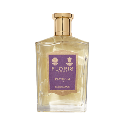 A clear glass bottle of Floris London EU Platinum 22 Eau de Parfum with a gold cap and purple label, created to honor Queen Elizabeth II.