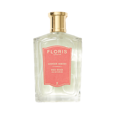 A clear glass bottle of Floris London EU Red Rose with a gold cap and pink label, showcasing the enduring scent of Rose Absolute.
