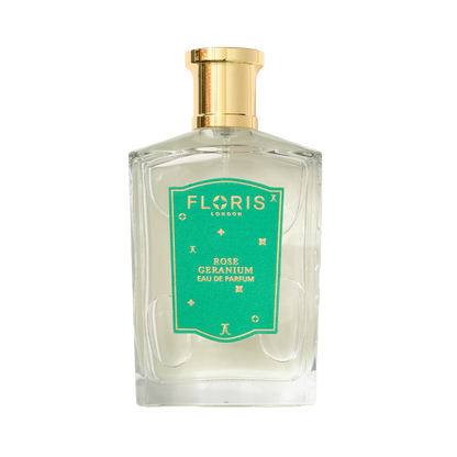 A clear glass bottle of Floris London EU’s Rose Geranium | Limited Edition Eau de Parfum with a green label and gold cap, on a white background.