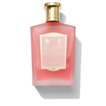 A pink bottle of Rose Mouthwash by Floris London, complete with a gold cap and a cream label embellished with the brand and product details in gold text. Infused with pure rosewater, it delivers a luxurious floral flavor.