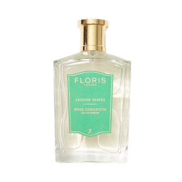 A clear glass bottle of Rose Geranium by Floris London EU, featuring a gold cap, green label, and notes of cedarwood and geranium.