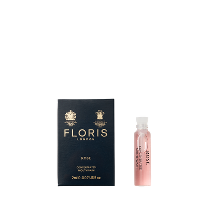 A Floris London Rose - Mouthwash box sits beside a 2ml vial labeled "ROSE," featuring pink mouthwash made with pure rosewater.