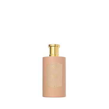 A beige bottle of Floris London Sandalwood & Patchouli Room Fragrance with a gold cap, featuring woody amber notes, set against a white background.