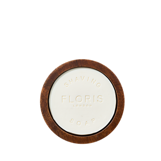 A round bar of Floris London Santal Shaving Soap sits in a wood bowl, embossed with "Floris London Shaving Soap & Bowl.