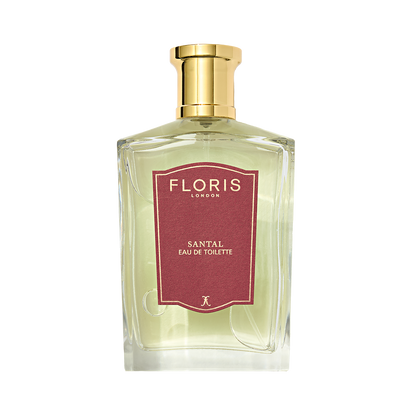 A clear glass bottle of Floris London Santal - Eau de Toilette features a gold cap, red label, and reveals its distinctive woody amber scent.