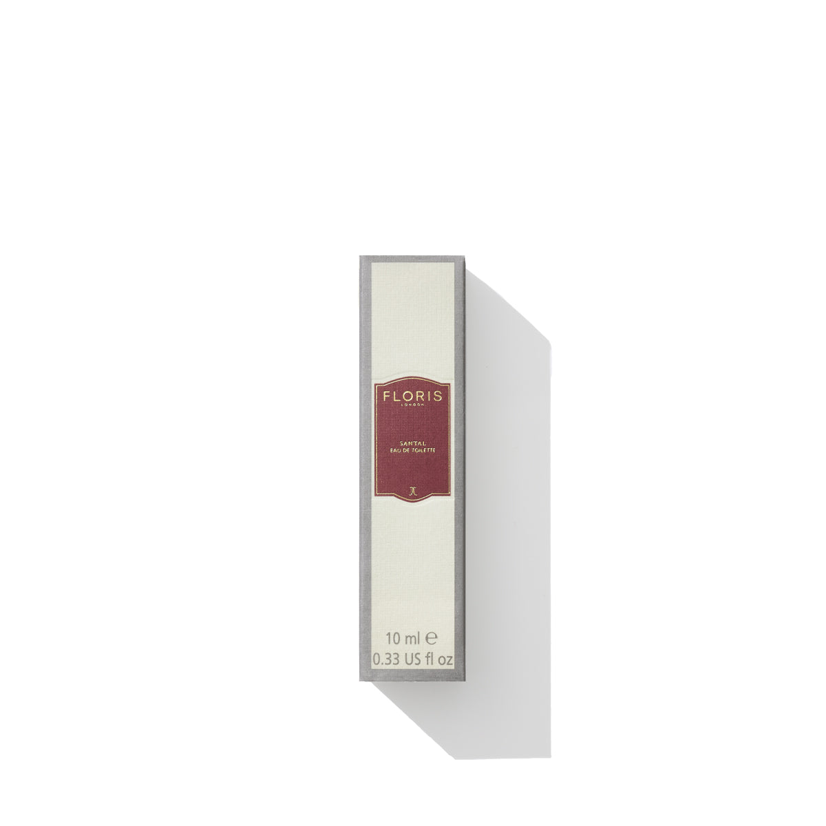 A rectangular box labeled "Floris London, Santal Eau de Toilette," contains 10 ml (0.33 US fl oz) of men's fragrance. The light-colored box features a red label in the center, embodying the warm and rich notes of sandalwood that define this exquisite scent.