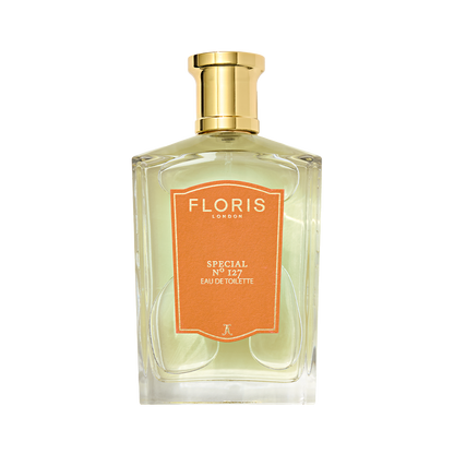 A clear glass bottle of Floris London Special No. 127 Eau de Toilette, a citrus floral scent, with a gold cap and orange label on white.