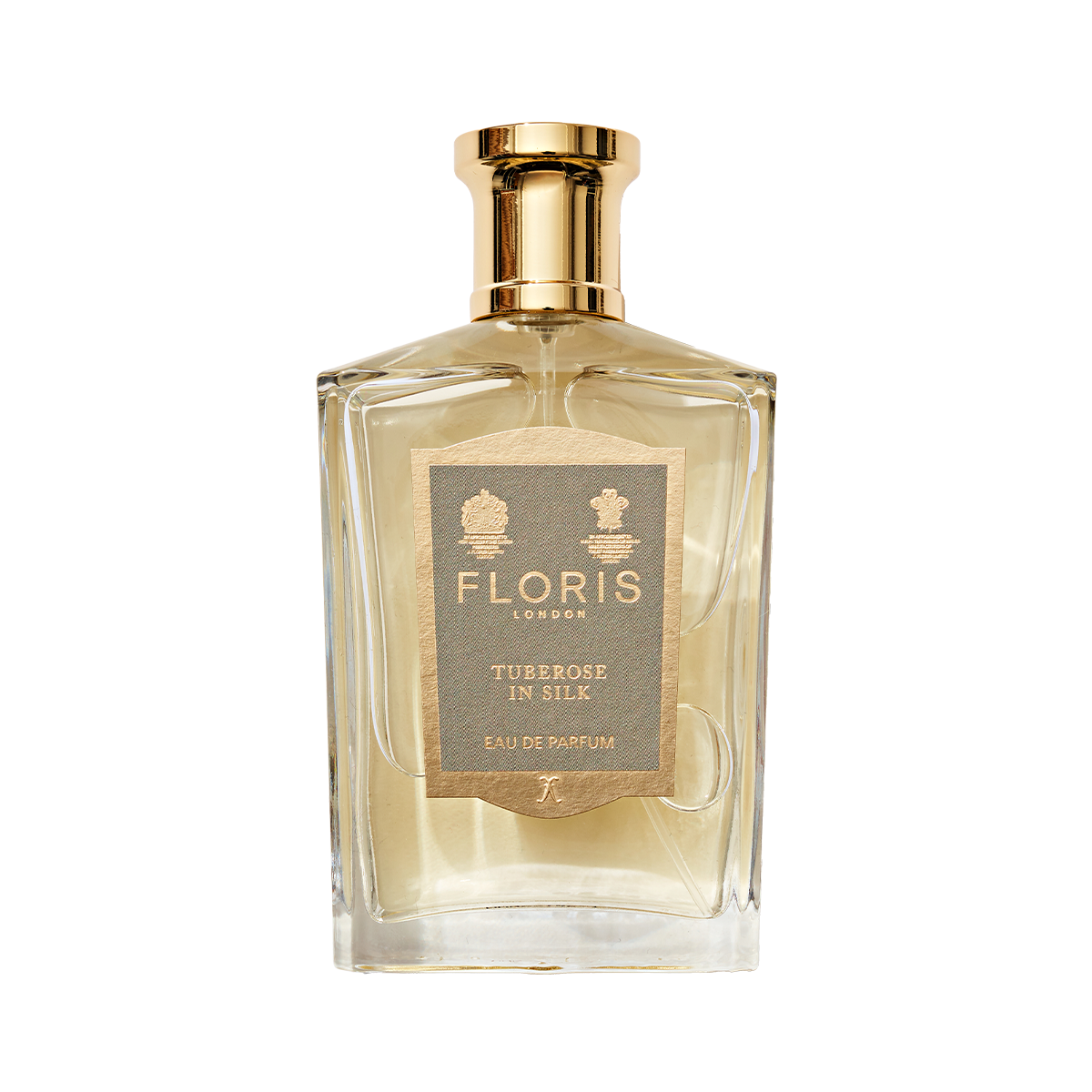 A clear glass bottle of Floris London Tuberose in Silk Eau de Parfum, a luxurious tuberose scent with a gold cap and beige front label.