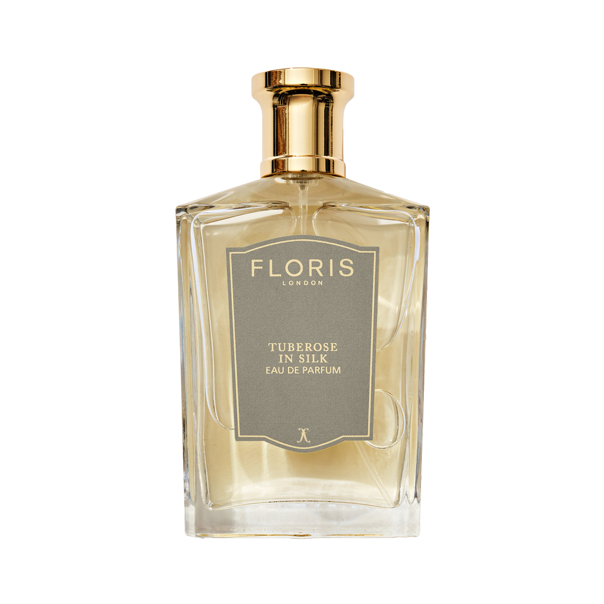 A clear glass bottle of Floris London Tuberose in Silk - Eau de Parfum, a luxurious fragrance with a gold cap and gray label.