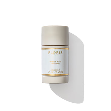 A cylindrical, beige deodorant stick labeled "White Rose - Deodorant Stick" by Floris London EU, featuring a white and gold label and containing 75 ml (2.5 fl oz), is displayed against a white background. Its alcohol and aluminum-free formula makes it ideal for sensitive skin.