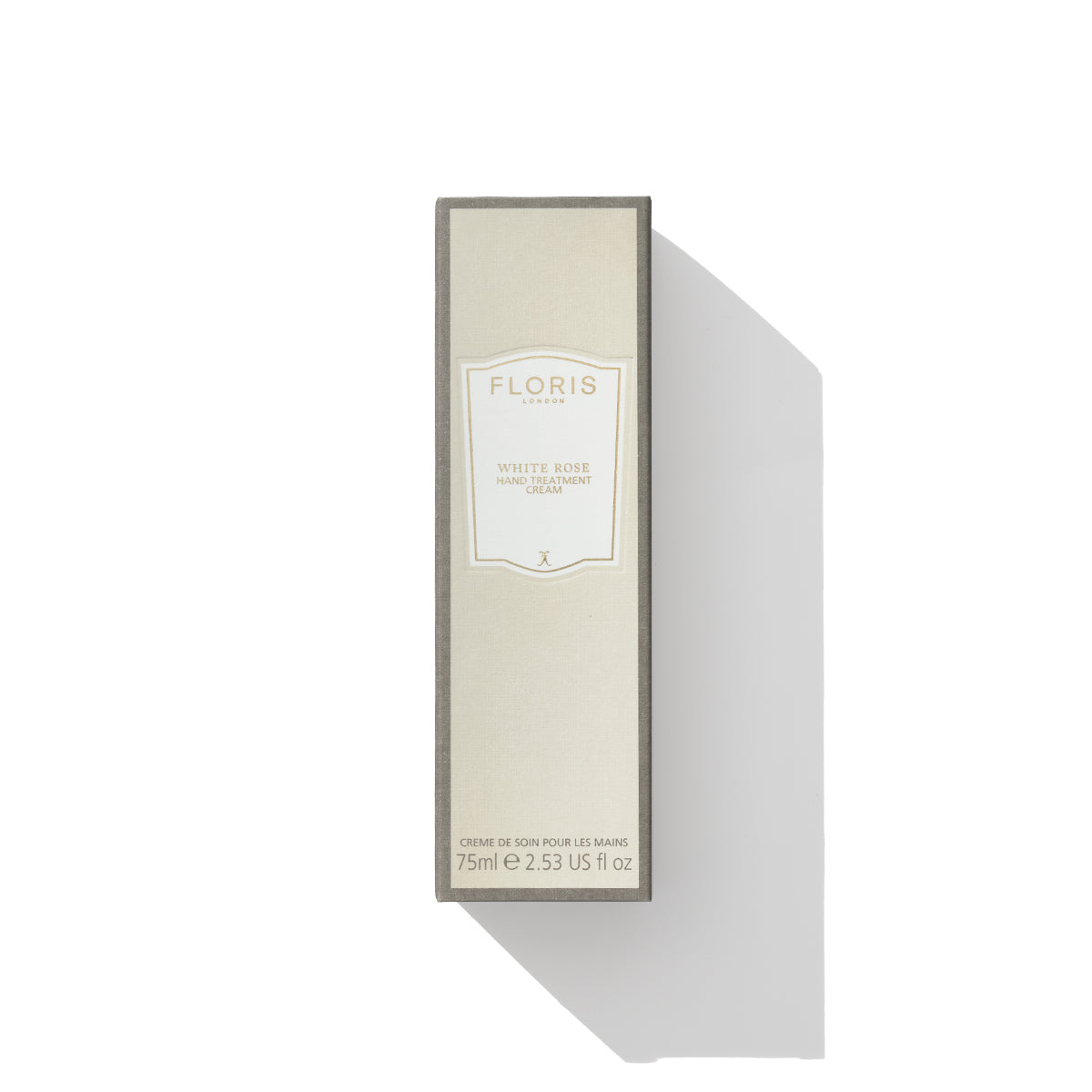 A beige box of White Rose - Hand Treatment Cream by Floris London EU, 75ml (2.53 fl oz), a luxury product designed to nourish the skin and tackle very dry hands, is positioned vertically on a white background with its shadow cast to the right.