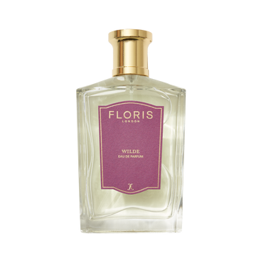 A clear glass bottle of Wilde - Eau de Parfum by Floris London EU, with a gold cap and purple label, displayed against a crisp white background.