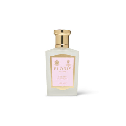 50ml frosted glass bottle with gold cap and pink and gold label reading 'Cherry blossom hair mist'.