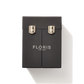 The black fragrance cased closed, showing the silver buckles to keep it closed with silver embossing label of Floris london.