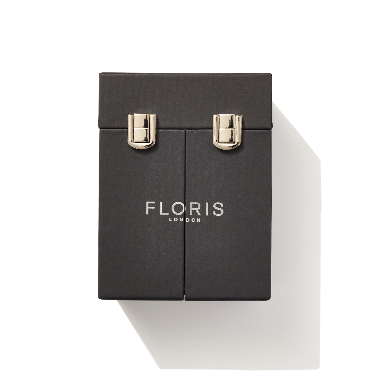 The black fragrance cased closed, showing the silver buckles to keep it closed with silver embossing label of Floris london.