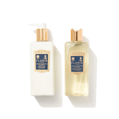 Two clear plastic pump bottles next to each other with navy and gold labels, containing the Night Scented Jasmine Bath & Body Set.