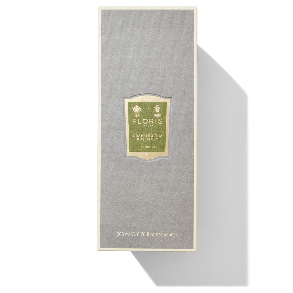 Grey box with green and gold label for the grapefruit and rosemary reed diffuser.