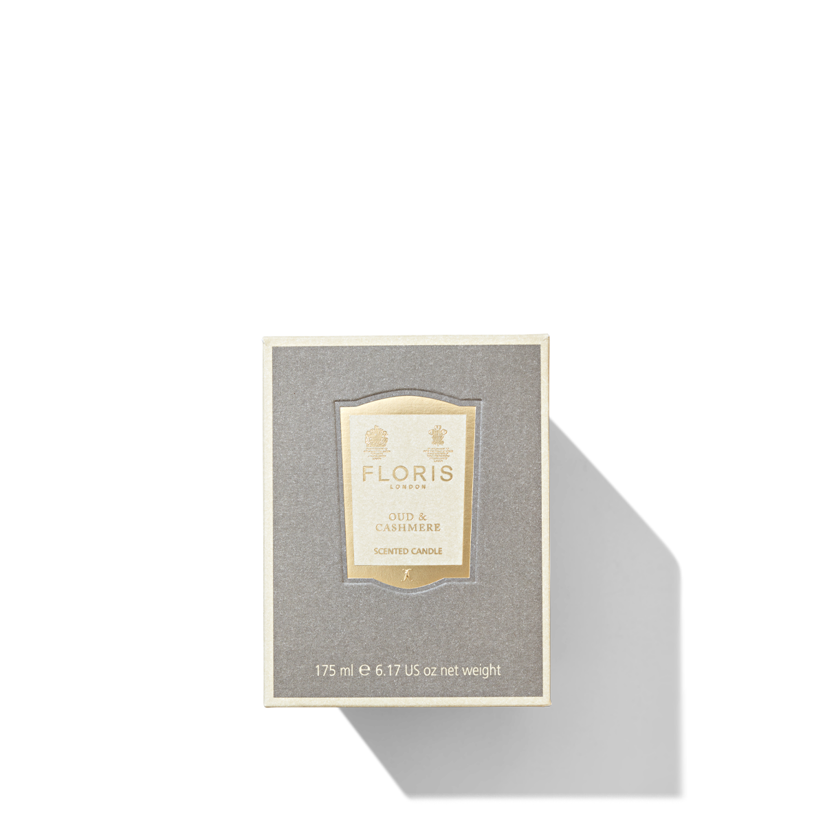 Medium square grey box with cream and gold label containing the Oud & Cashmere Candle